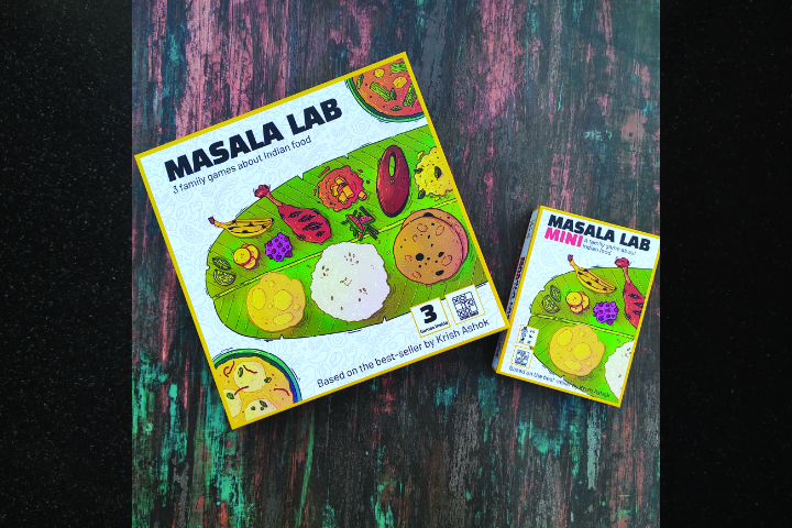 Board game Masala Lab placed against a wooden background. Title reads Masala Lab - 3 family games about Indian food. Based on the best-seller by Krish Ashok